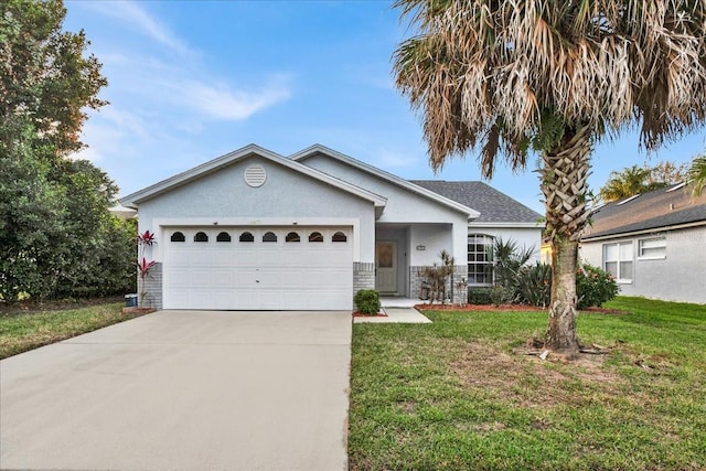 single story home featuring a garage and a front yard