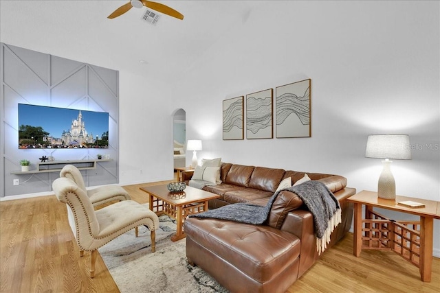 living room featuring ceiling fan and light hardwood / wood-style flooring