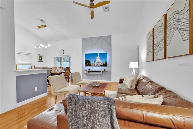 living room with vaulted ceiling, ceiling fan, and light hardwood / wood-style flooring