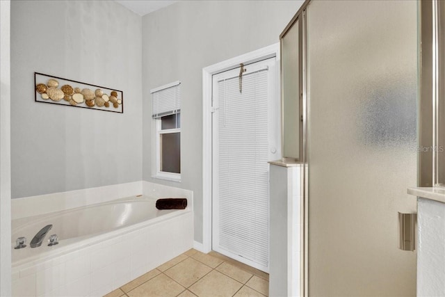 bathroom with tile patterned floors and separate shower and tub