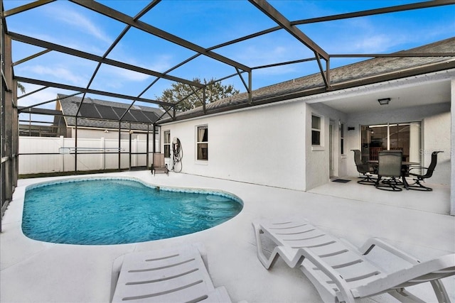 view of swimming pool with a patio and a lanai