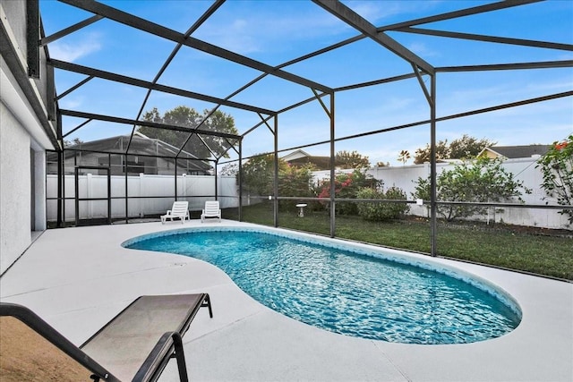 view of swimming pool featuring a patio and glass enclosure