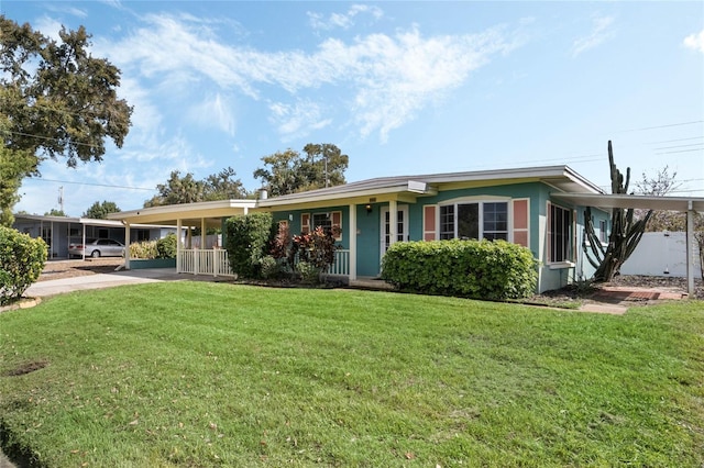 single story home featuring stucco siding, a carport, and a front yard