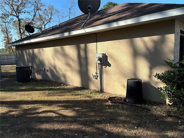 view of side of home with central air condition unit