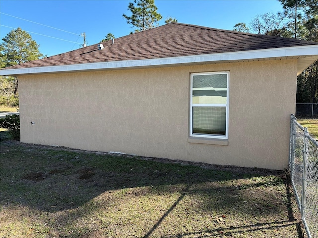 view of side of home featuring a lawn