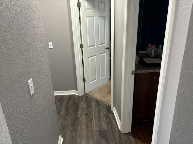 corridor featuring dark wood-type flooring