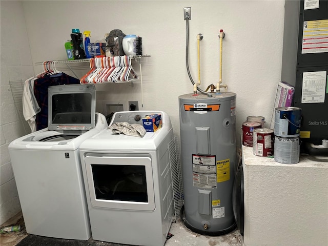 laundry room featuring electric water heater, heating unit, and washer and clothes dryer