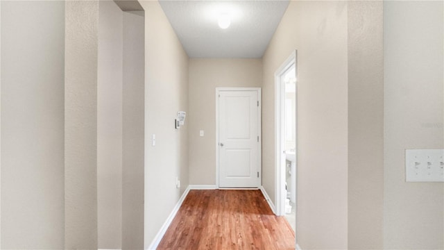 hallway featuring hardwood / wood-style flooring