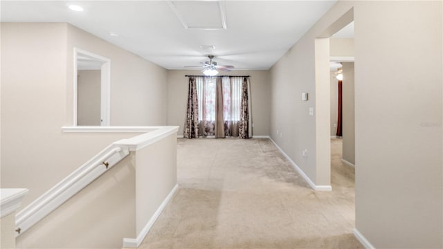 hallway featuring light colored carpet