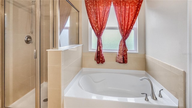 bathroom featuring separate shower and tub