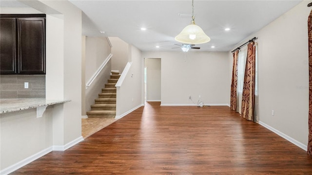 interior space with dark hardwood / wood-style flooring and ceiling fan