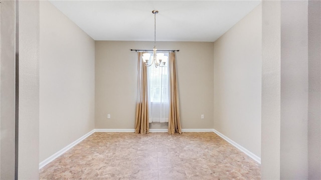 empty room with a notable chandelier