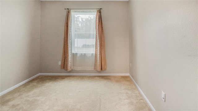 unfurnished room with light colored carpet