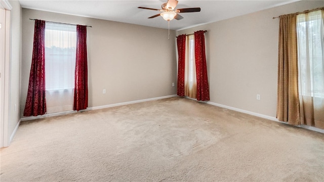 carpeted empty room featuring ceiling fan