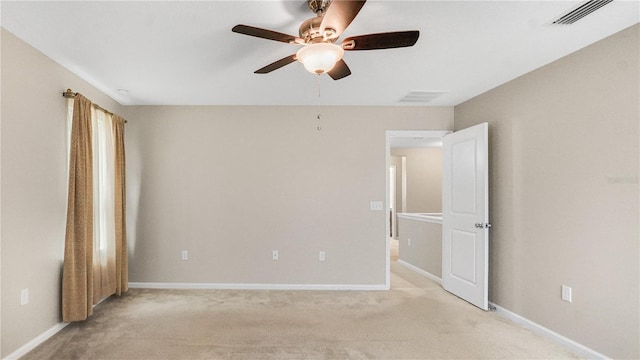 spare room with light carpet and ceiling fan