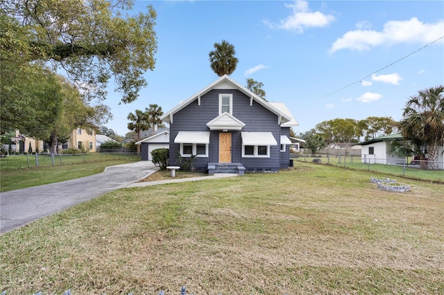 bungalow-style home with a front yard