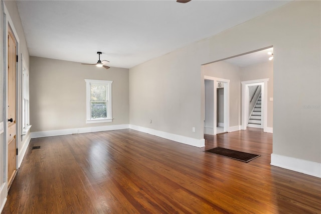 unfurnished room featuring ceiling fan and dark hardwood / wood-style flooring