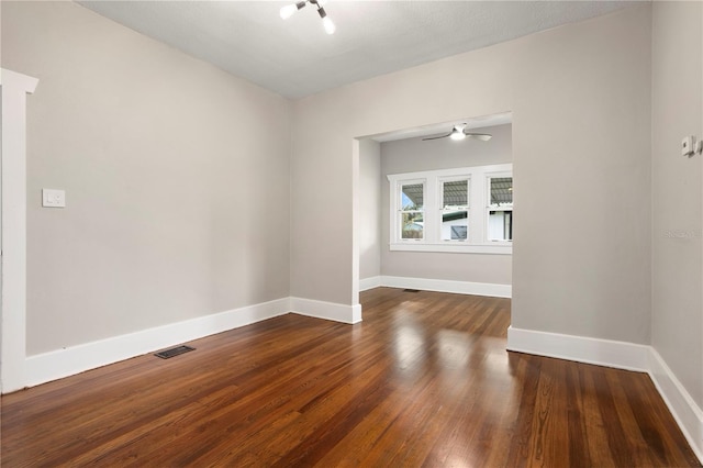 unfurnished room featuring ceiling fan and dark hardwood / wood-style floors