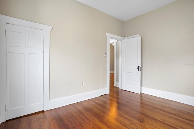 unfurnished bedroom featuring dark hardwood / wood-style floors