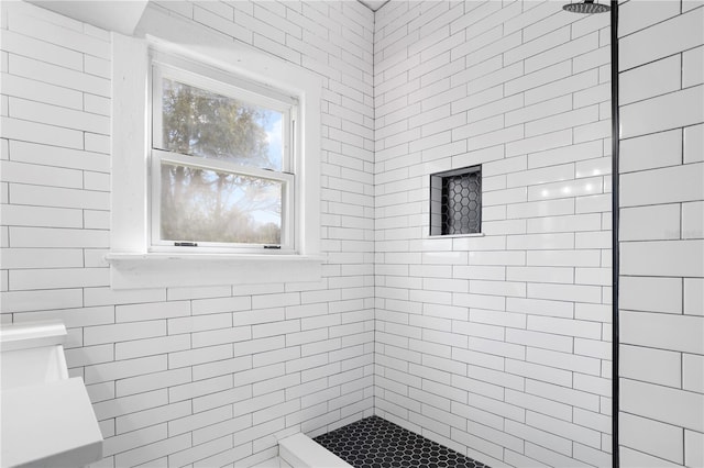 bathroom with tiled shower