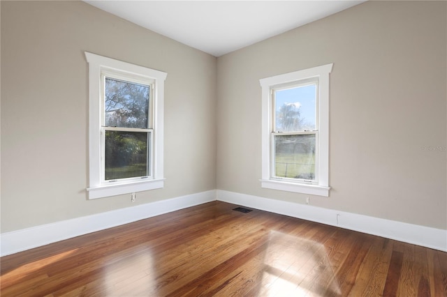 empty room with hardwood / wood-style flooring