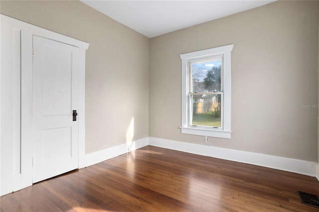 spare room with dark hardwood / wood-style flooring