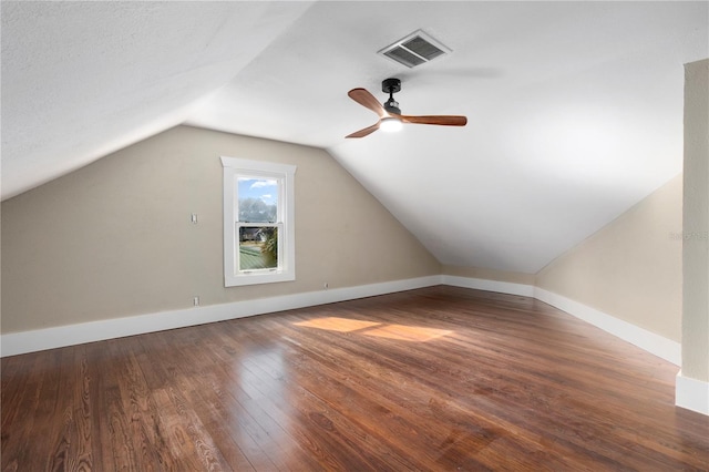 additional living space featuring lofted ceiling and dark wood-type flooring