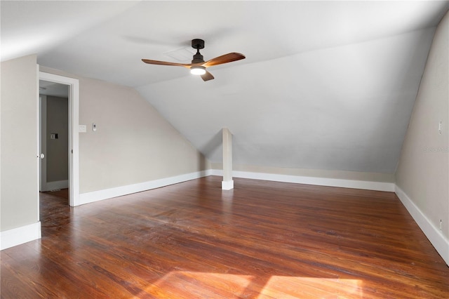 additional living space with vaulted ceiling, dark hardwood / wood-style floors, and ceiling fan