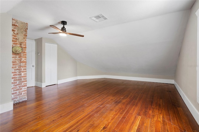 bonus room featuring lofted ceiling, dark hardwood / wood-style floors, and ceiling fan