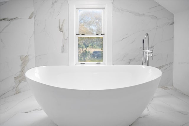 bathroom featuring tile walls and a tub