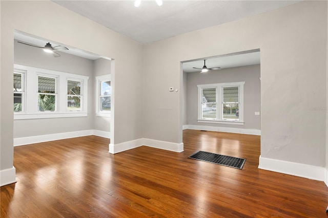 empty room with wood-type flooring and ceiling fan