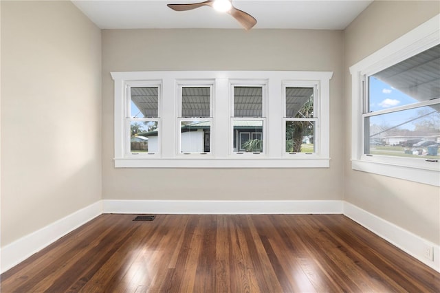 spare room featuring ceiling fan and dark hardwood / wood-style floors