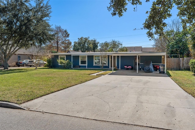 ranch-style house featuring a front lawn and a carport