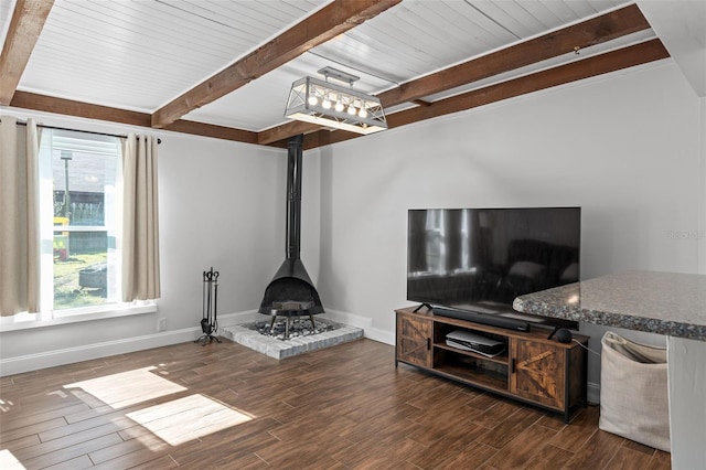 living room featuring a wood stove and beamed ceiling