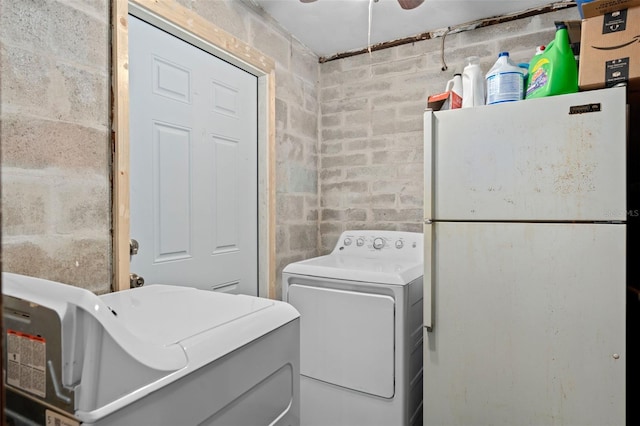 clothes washing area featuring washer and clothes dryer