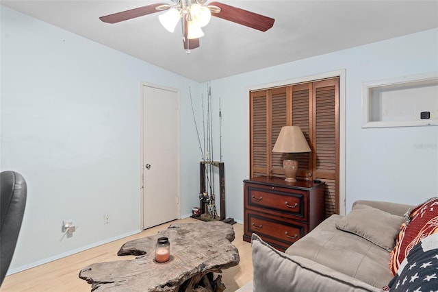 bedroom with ceiling fan, a closet, and hardwood / wood-style flooring