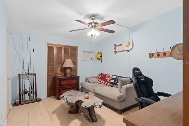 living room with ceiling fan and light hardwood / wood-style floors