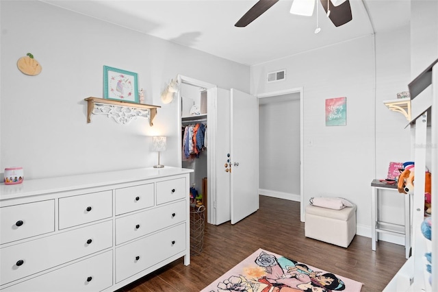 bedroom featuring ceiling fan, a closet, and dark wood-type flooring