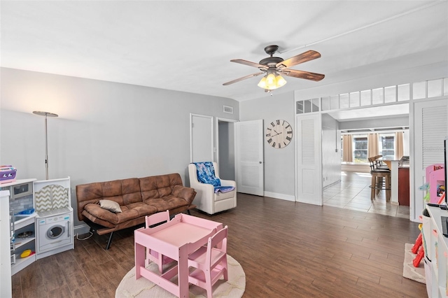 living room with ceiling fan and dark hardwood / wood-style floors