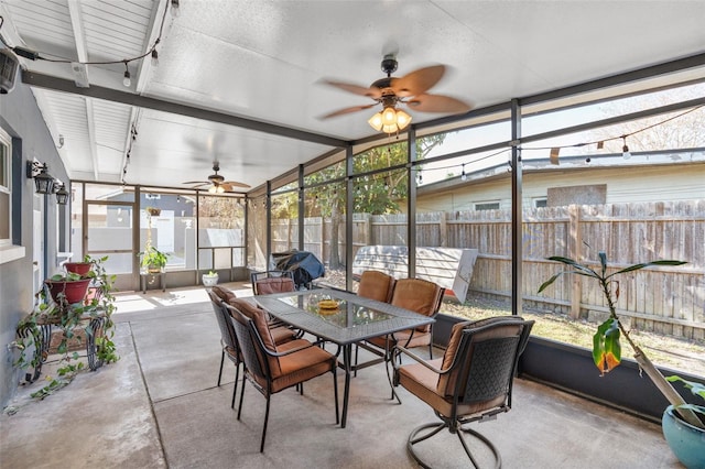 sunroom / solarium with ceiling fan and lofted ceiling