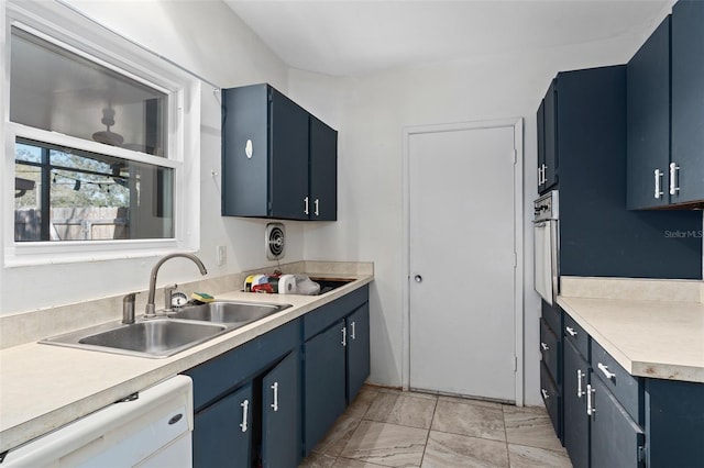 kitchen with white dishwasher, sink, blue cabinetry, and wall oven