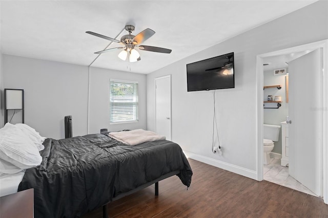 bedroom featuring ceiling fan, connected bathroom, and hardwood / wood-style floors