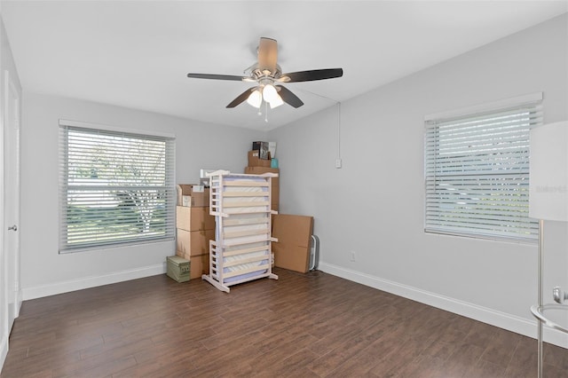 interior space with ceiling fan and dark hardwood / wood-style floors