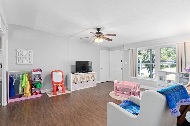 living room featuring ceiling fan and dark hardwood / wood-style flooring