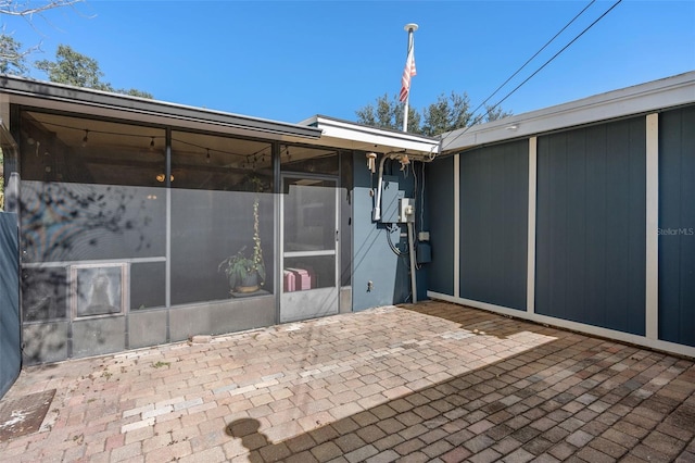 view of patio / terrace featuring a sunroom