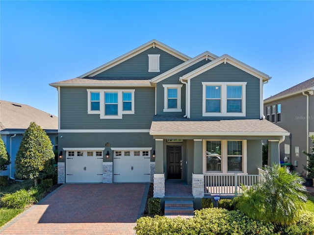 craftsman-style home featuring covered porch and a garage