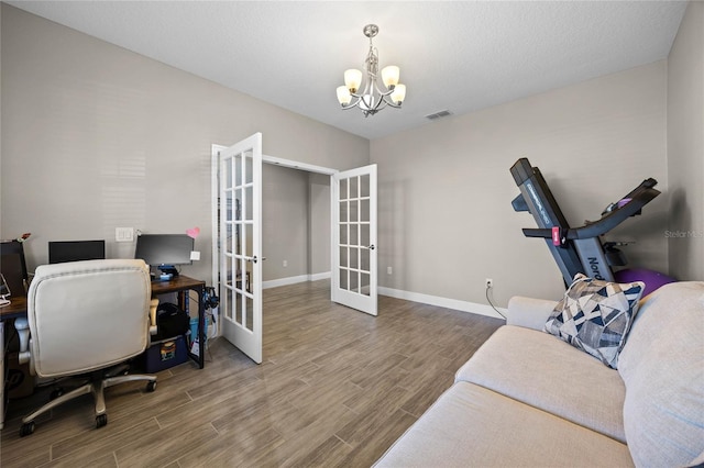 home office with french doors and a notable chandelier