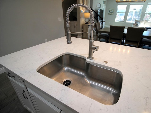 room details with light stone counters and sink