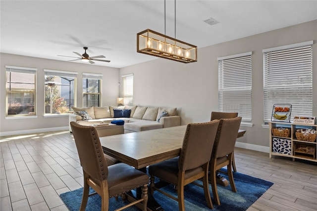 dining area with ceiling fan and light wood-type flooring