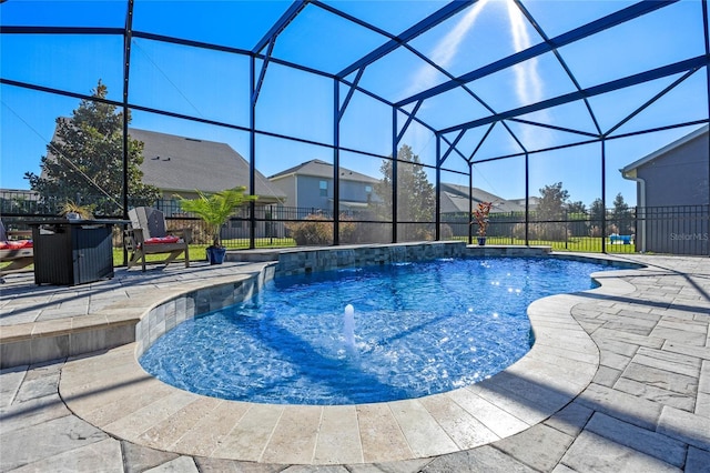 view of swimming pool with a lanai, pool water feature, and a patio